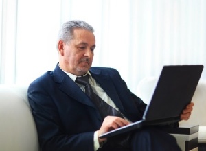 CEO sitting with laptop